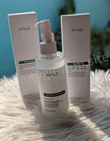 Anua skincare product with pump bottle and boxes on a textured surface