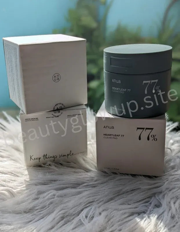 Cosmetic jar and packaging with '77%' branding on a textured surface.