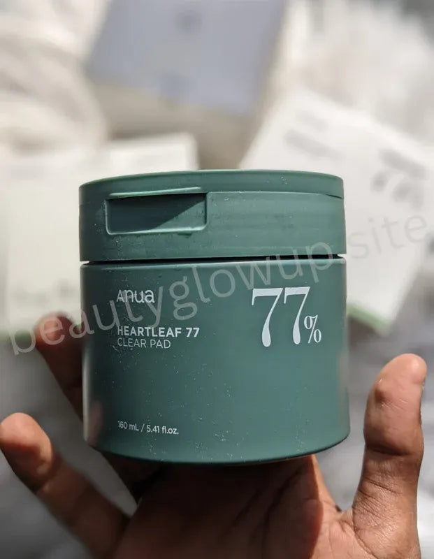 Cosmetic jar and packaging with '77%' branding on a textured surface.