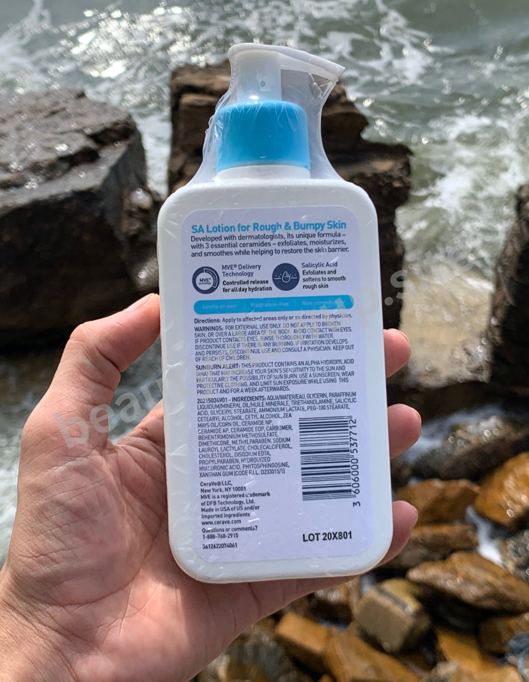 CeraVe SA Lotion for Rough & Bumpy Skin held in front of a water background