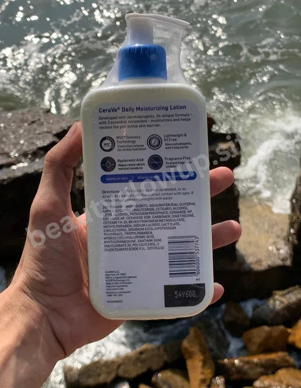 CeraVe daily moisturizing lotion held by a hand with a natural background