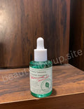 axis-y-Bottle of skincare serum on a wooden surface