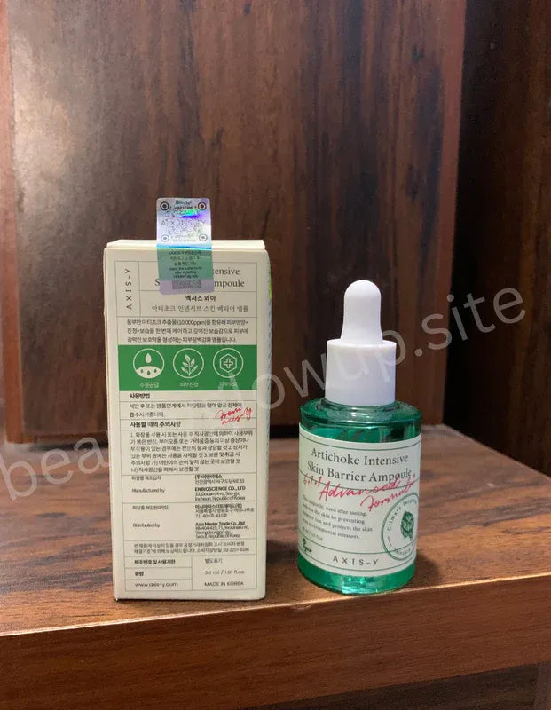 axis-y skincare product on a wooden surface with a box in the background.