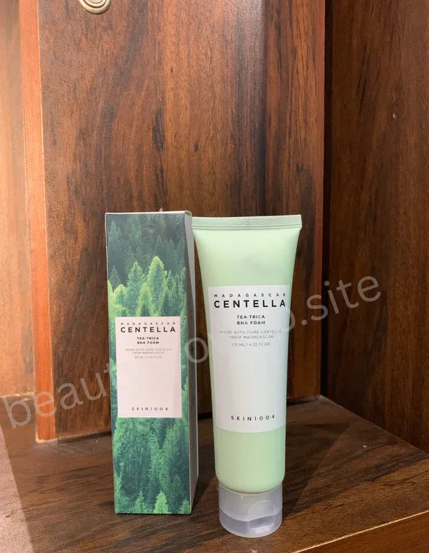 Skintone Madagascan Centella tea tree BHA foam with packaging on a wooden surface