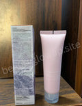 Pink skincare tube and box on a wooden surface